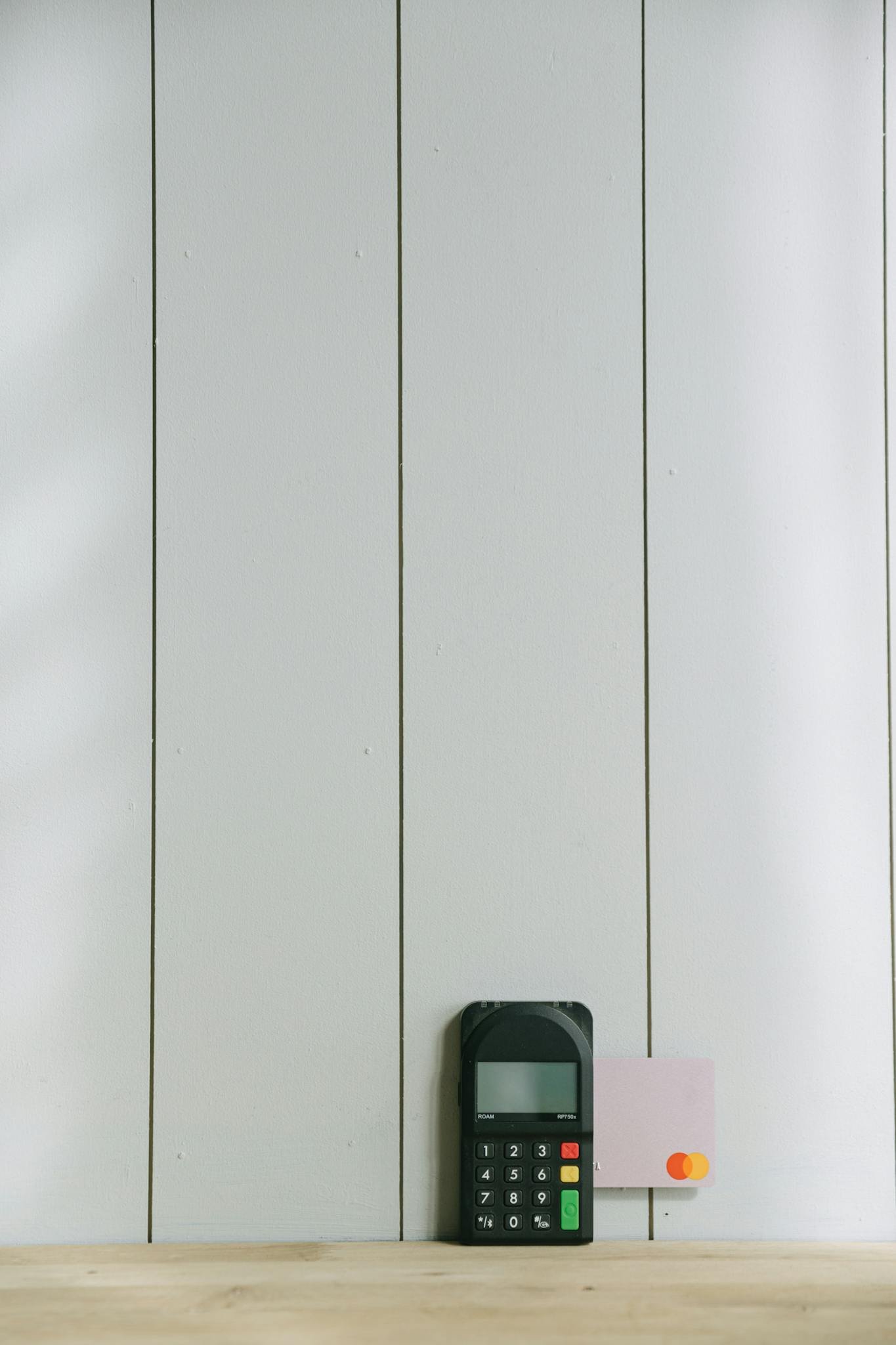 a sleek payment terminal with buttons against