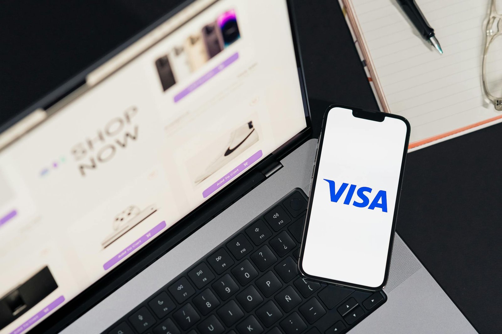 smartphone displaying visa on a laptop for